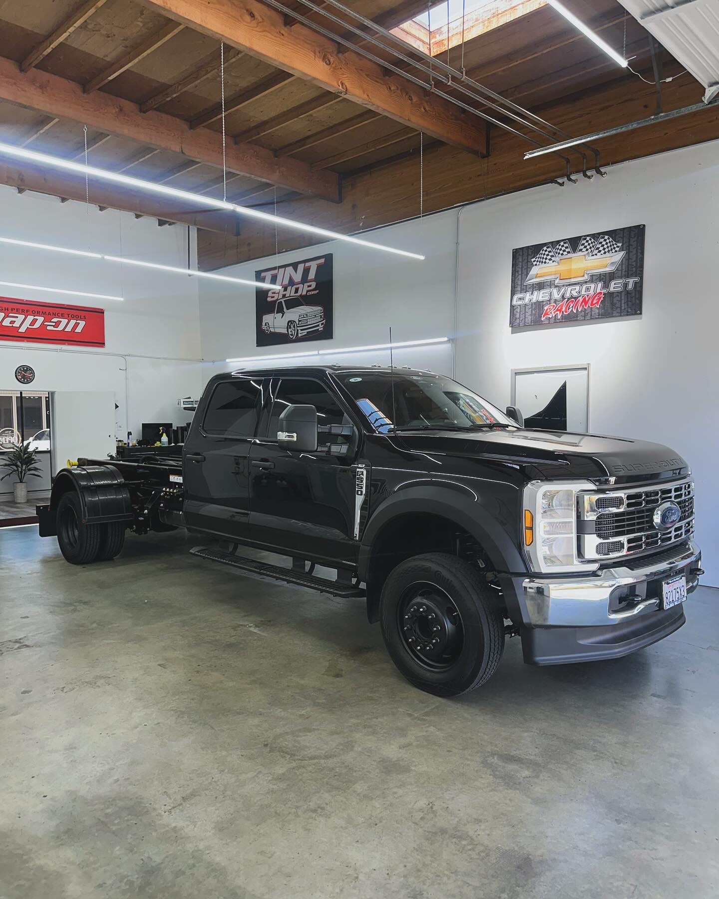 Black Ford F-550 Super Duty with dark tint